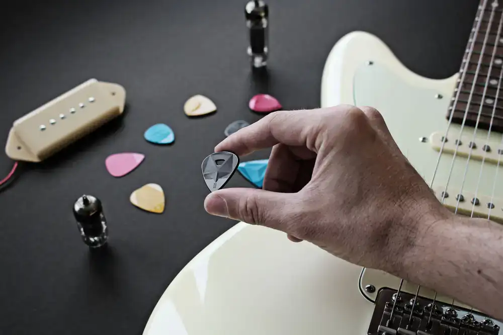 Assortment of guitar strings, straps, and picks